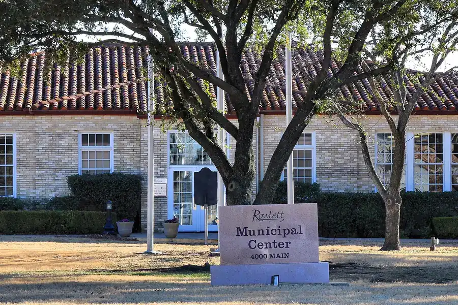 Rowlett Municipal Center building with a tile roof and a stone sign in Rowlett, Texas